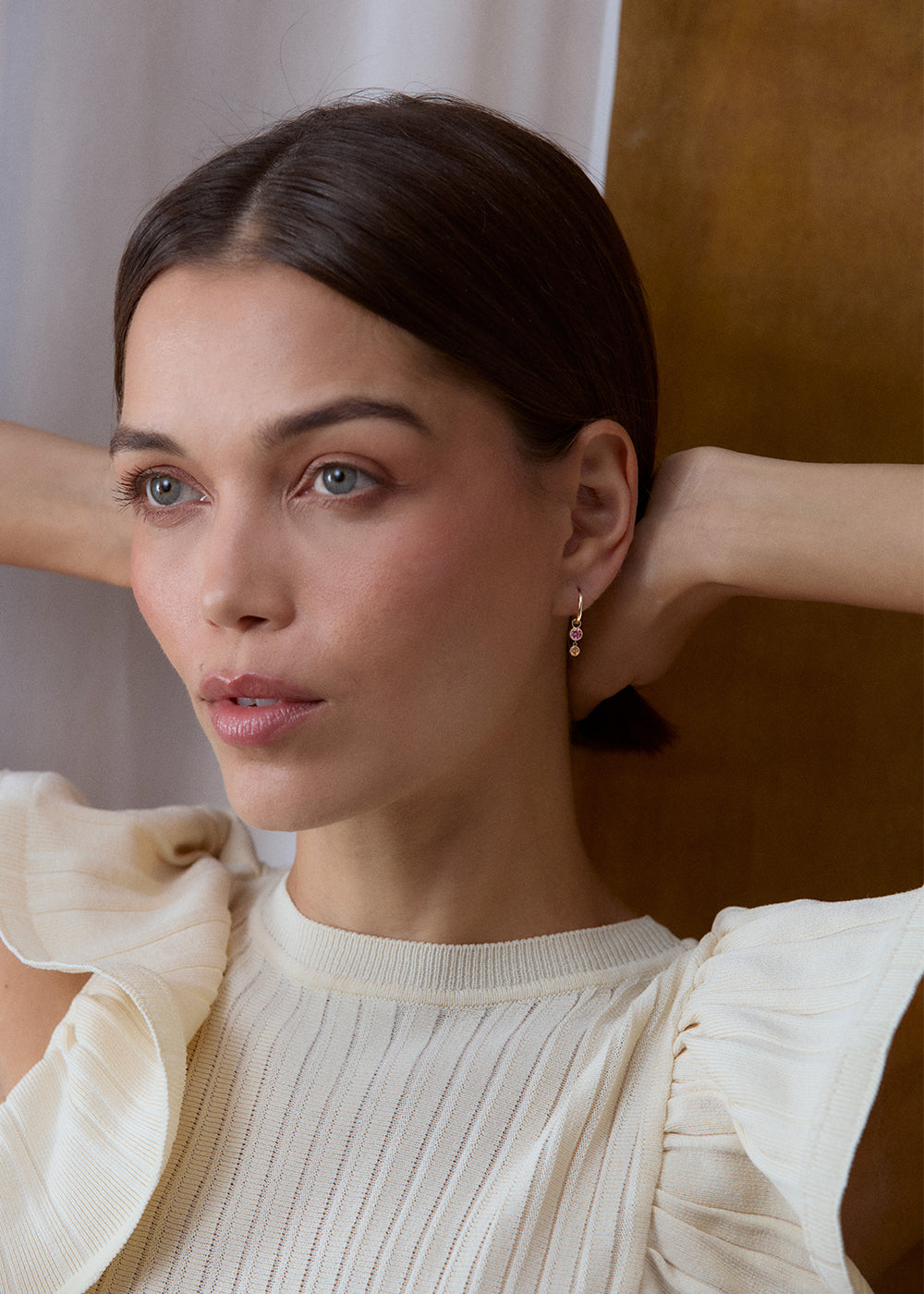 9k yellow gold pink tourmaline and orange garnet drop earrings worn with a cream top.