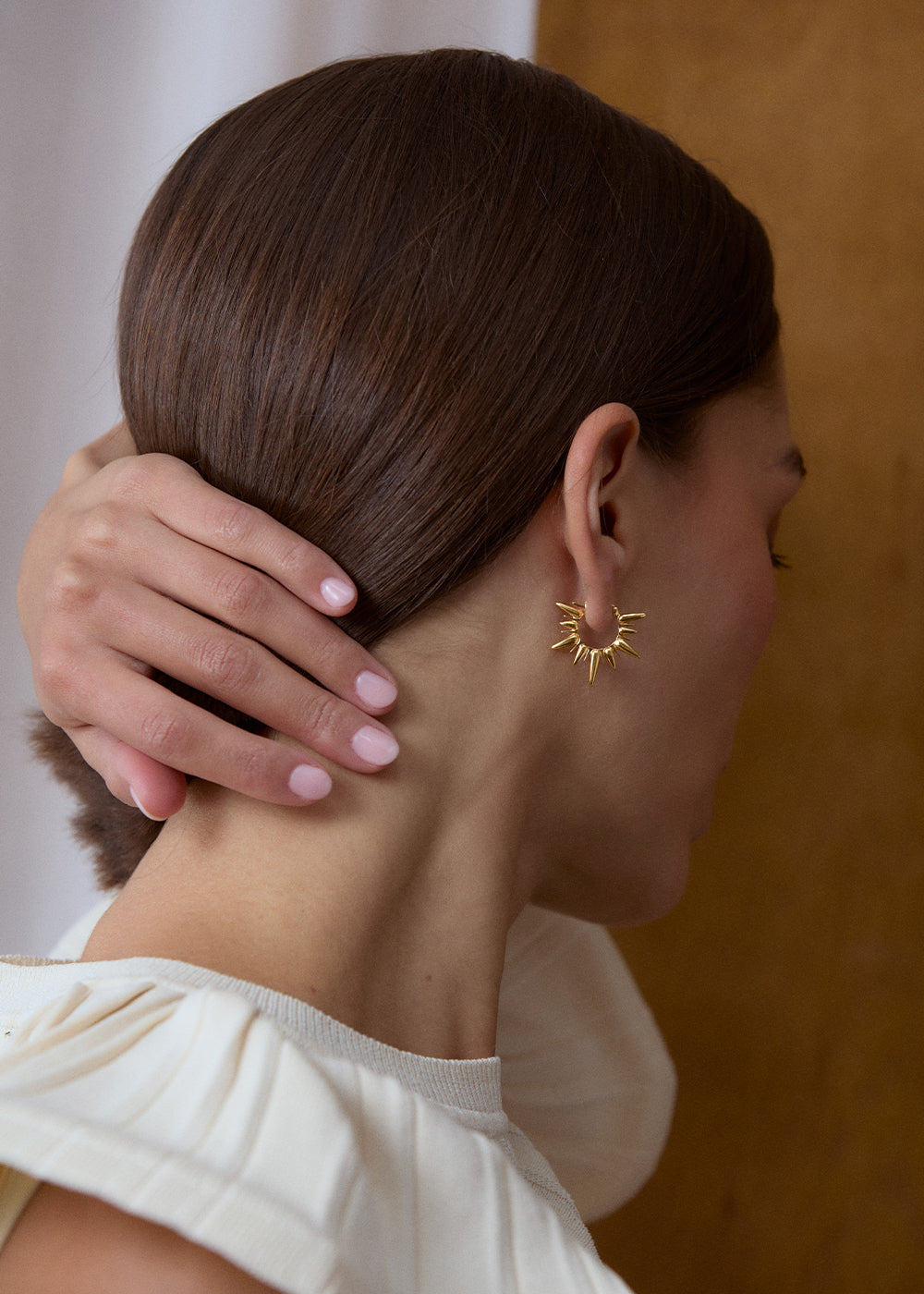18k gold vermeil sunburst hoop worn on the ear, shown from behind.