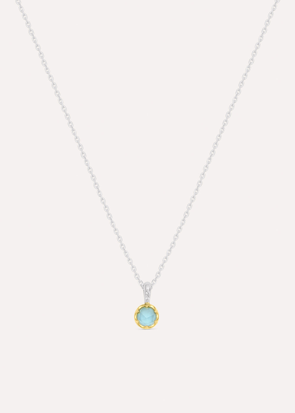 Sterling silver chain necklace with a round pale blue aquamarine pendant in an 18k gold vermeil setting, front view.