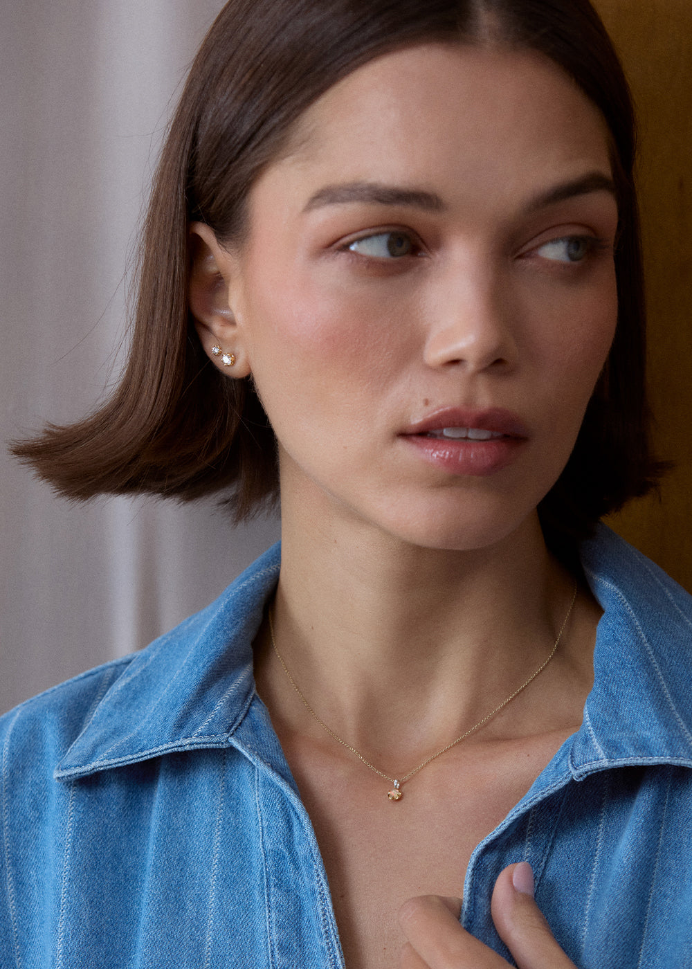 Small iridescent opal charm in an 18k gold vermeil setting, worn on a fine chain.