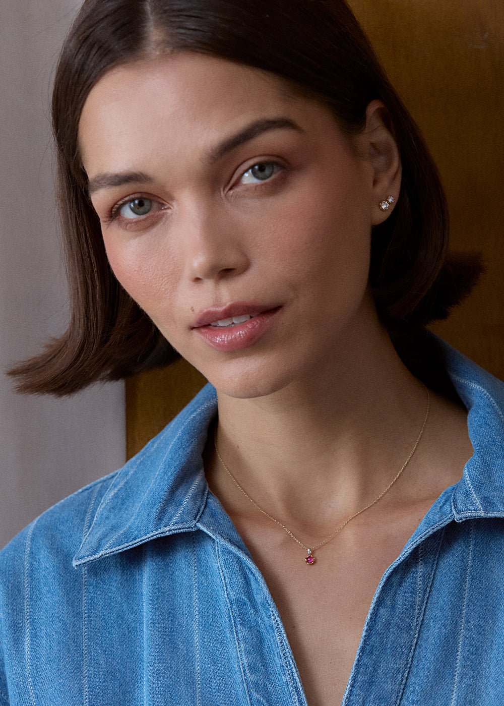 Round pink rhodolite garnet charm in a scalloped 18k gold vermeil setting, worn on a fine chain.