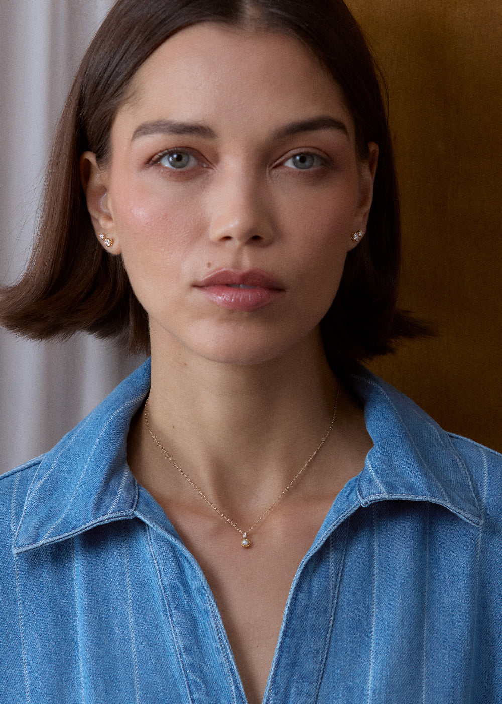 Small white pearl charm with an 18k gold vermeil setting and silver bail, worn on a fine chain.